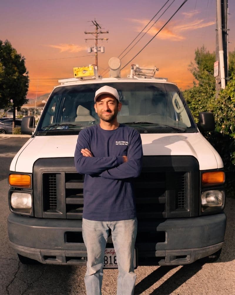 Cesar behind the wheel of his work truck, ready for the next job