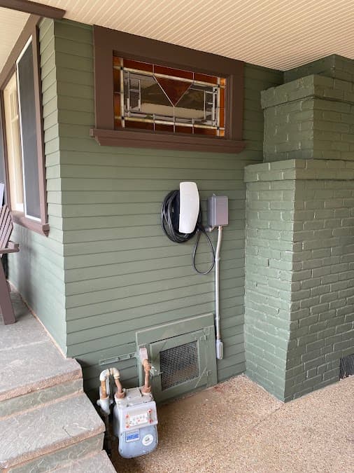 Wall-mounted EV charger install on a craftsman-style home